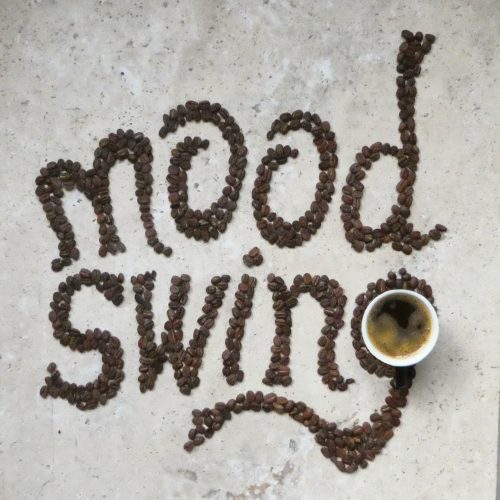 Mood swing,creative typography made with coffee beans on stone table
