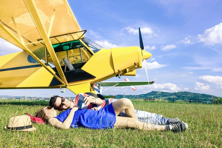 Relaxed couple of lovers having a rest during charter airplane excursion