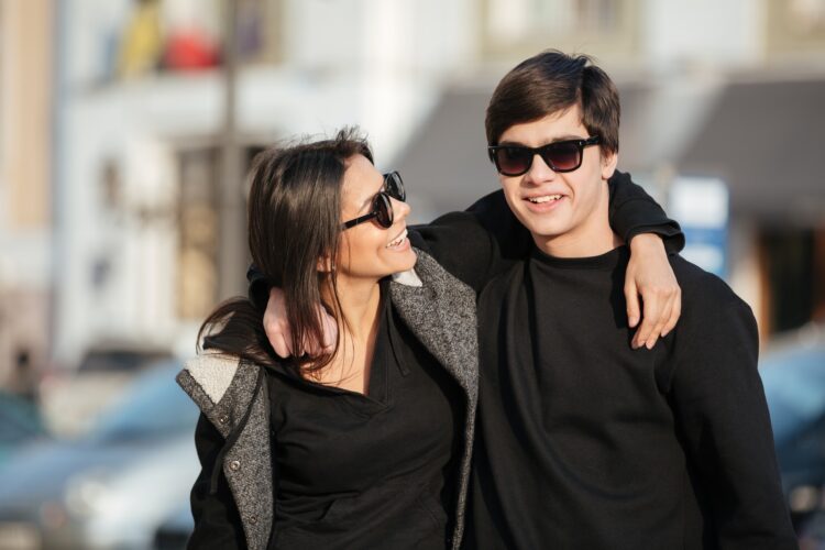 Happy young woman walking outdoors with her brother