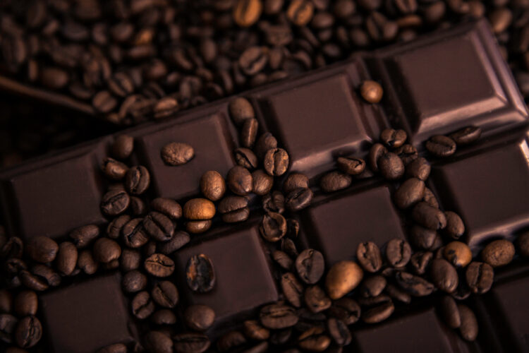Roasted coffee beans and chocolate bar close-up