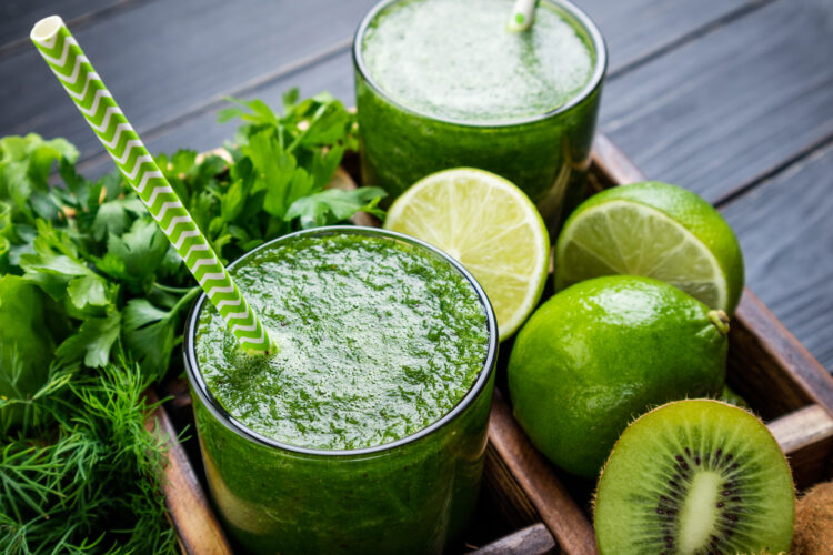 Green smoothie with vegetables, fruits and herbs. Healthy smoothie with spinach, lime, kiwi