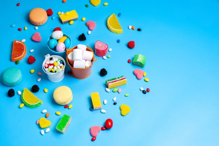 a top view colorful candies different multicolored candies and cookies on the blue background candy
